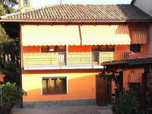 Casa arancione e gialla con balcone di Casa Sammo a Piobesi dʼAlba