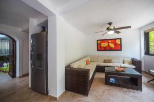 a living room with a couch and a refrigerator at Casa Silvana - Villas del Palmar in Sayulita