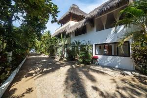 a road leading to a house with a building at Casa Silvana - Villas del Palmar in Sayulita