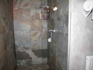 a bathroom with a shower with a glass door at Agropensiunea Maris in Feleacu