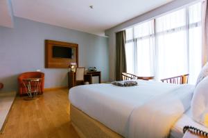 Uma cama ou camas num quarto em Azzeman Hotel
