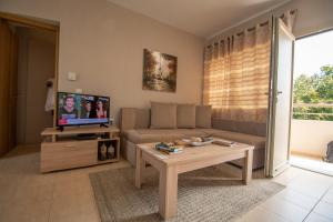 a living room with a couch and a table at Euphoria Skiathos in Skiathos