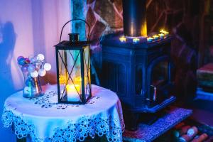 a lantern sitting on a table next to a stove at Agroturystyka uDuraja in Kiczora