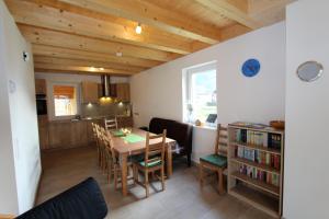 a dining room and kitchen with a table and chairs at Chalet Underhill in Kötschach