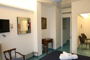 a hotel room with a bed and a mirror at L'Arazzo in San Benedetto del Tronto