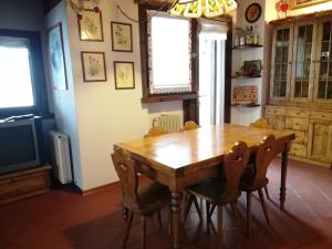 a dining room with a wooden table and chairs at Appartamento Piancavallo in Piancavallo +30 photos