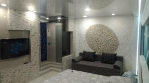 a living room with a couch and a flat screen tv at Falcon-X apartment in Mykolaiv