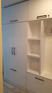 a white cabinet with empty shelves in a room at New Gudauri, Loft 1 in Gudauri