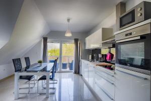 a kitchen with a table and chairs and a dining room at Apartments Teja in Kranjska Gora