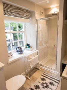 a bathroom with a shower and a window at Rockport Lodge in Cushendun