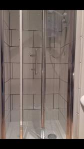 a shower with a glass door in a bathroom at The Loft in Hollingwood