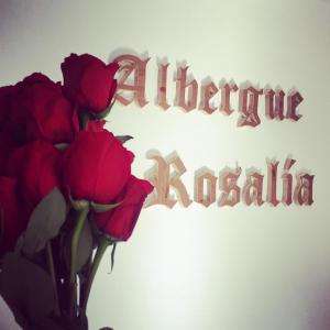 a bouquet of roses in front of a sign at Albergue Rosalia / Pilgrim Hostel in Castrojeriz