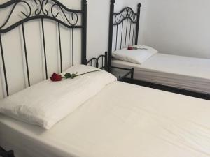 a bed with two pillows and two nightstands at Albergue Rosalia / Pilgrim Hostel in Castrojeriz
