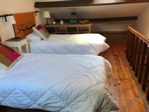 a bedroom with two beds and a wooden floor at Flat with Terrace in Adamastor in Lisbon