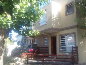 a house with a car parked in front of it at Maraja in Mar de Ajó