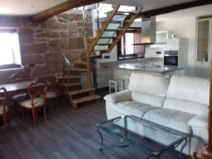 a living room with a couch and a glass table at Casa Tras Do Rio in Coles
