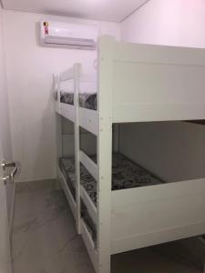 a white bunk bed in a small room at Apartamento no Edifício Florida Terrace in Matinhos