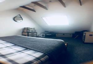 a bedroom with a bed and a skylight at Ayrshire Holiday Cottage in Girvan