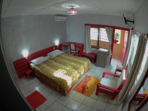 a bedroom with a bed and chairs in a room at Hotel Napoleon Lagune in Lom&eacute;
