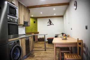 a small kitchen with a table and a room with at Valle del sol I in Pajares