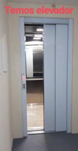 an open door to a room with a temos elevator at Apto Paulino Frente Mar in Piúma