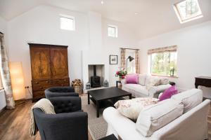 a living room with two couches and a table at The Wild Farm Cottage in Mullingar