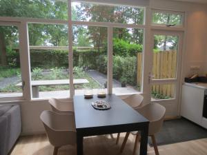 a kitchen and living room with a table and chairs at 't Salehemse Huuske in Zelhem +17 photos