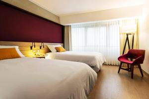 Postel nebo postele na pokoji v ubytování Mercure Ariosto Lima