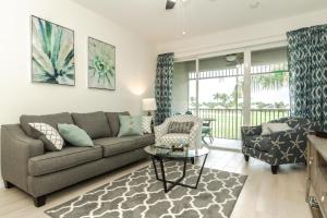 a living room with a couch and a table at GreenLinks Golf View Villa Mustang at Lely Resort in Naples