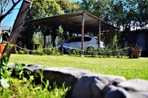 a car parked under a shed in a yard at Cabañas Villa del Sol in Salta