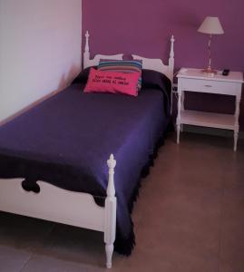 a bedroom with a bed with a pillow on it at Habitación casa de campo. in San Rafael