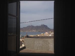 a view of the ocean from a window at Residencial Monte Cara in Mindelo