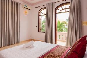 a bedroom with a bed and a large window at Rio 6a homestay in Vung Tau +24 photos
