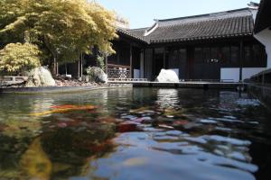a koi pond in front of a building at Shanghai Daoli one step garden(PVG&International Resort) in Shanghai
