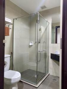 a bathroom with a glass shower with a toilet at Good Hope Hotel in Skudai