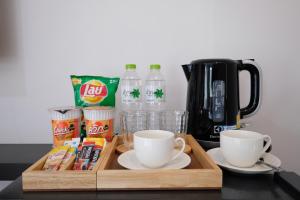 a wooden tray with two cups and a coffee maker at Living at Sphere Apartment in Ao Nang Beach