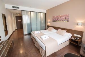 Ένα ή περισσότερα κρεβάτια σε δωμάτιο στο ARVA Abad San Antonio