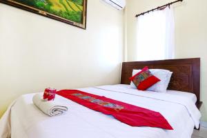 Postel nebo postele na pokoji v ubytování Jungut Guest House Ubud