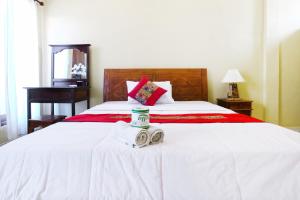 Postel nebo postele na pokoji v ubytování Jungut Guest House Ubud
