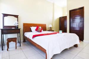 Postel nebo postele na pokoji v ubytování Jungut Guest House Ubud