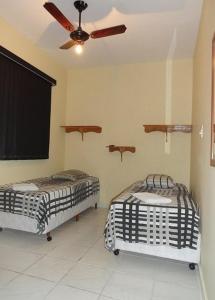 מיטה או מיטות בחדר ב-Hotel Capriccio Mauá