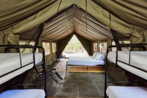 a room with three bunk beds in a tent at RAC Margaret River Nature Park in Margaret River Town