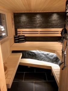 a sauna with two benches in a cabin at Lovely studio apartment seaview & private sauna in Lerum