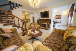 a living room with a couch and a table at Ikonomov House in Bansko