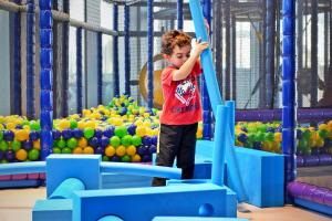 a young boy is playing on a playground at Yas Island Rotana Abu Dhabi in Abu Dhabi