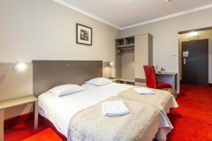 Łóżko lub łóżka w pokoju w obiekcie Hotel New Skanpol