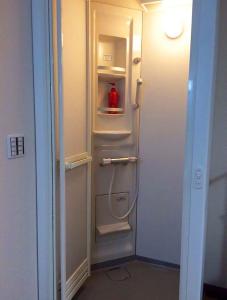 a refrigerator with its door open with a bottle in it at Mikawa House Osaka Castle in Osaka