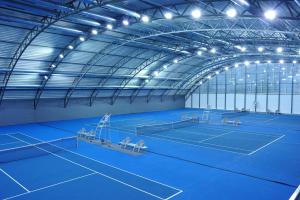 an indoor tennis court with two tennis courts at Hotel EMPIRE in Trnava