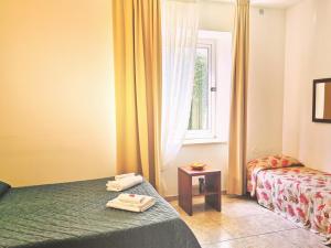 a hotel room with a bed and a window at Hotel San Martino in Cassibile