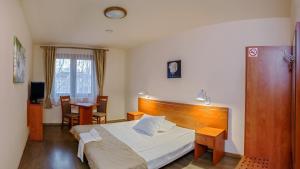 a bedroom with a bed and a table and chairs at Zajazd Beskidy in Żywiec +38 photos